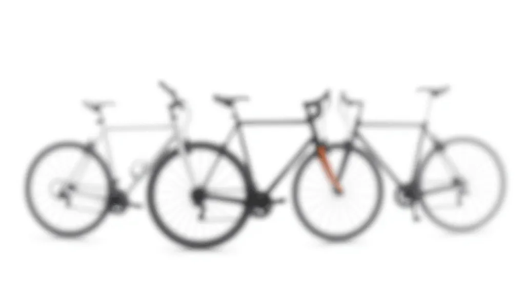 Close-up of different bike frame styles showing hybrid upright position compared to racing geometry
